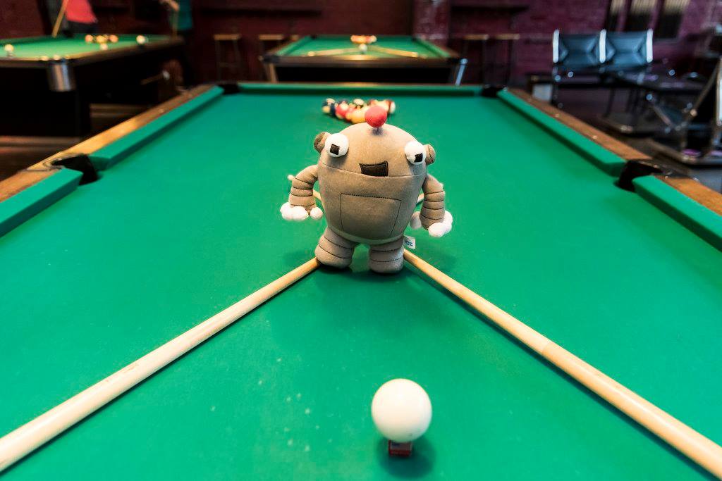 Roger, the Moz bot, shooting pool at MozCon